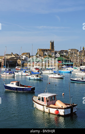 Penzance fishing boats in harbour man with dog Stock Photo - Alamy