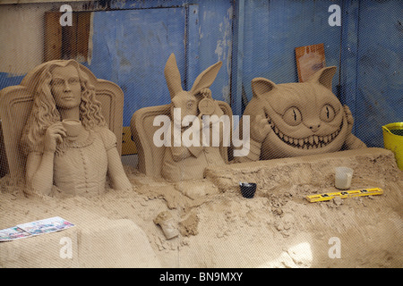 Sand sculptures of Alice in Wonderland characters on the beach at Weymouth, Dorset UK in June Stock Photo