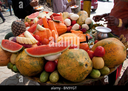 Fruit platter kiosk at 'BBD Bagh' in Kolkata (Calcutta). Freshly cut fruits are a popular street food in Indian towns and cities Stock Photo