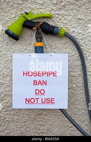 Hosepipe ban sign with notice forbidding the use of garden water hose drought UK Europe Stock Photo