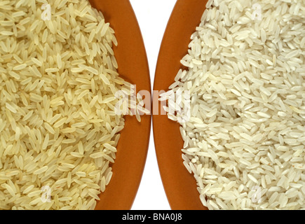 White and yellow (parboiled) rice in two ceramic plates isolated on white Stock Photo