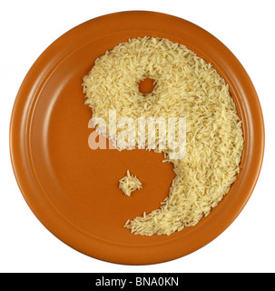Rice on a plate forming eating face profile and Yin Yang symbol at the same time Stock Photo