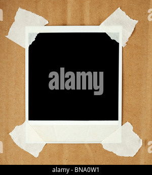 Blank photo card with masking tape on a cardboard Stock Photo