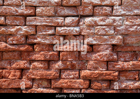 Red brick wall which has been affected by water erosion/weathering in Venice Italy Stock Photo