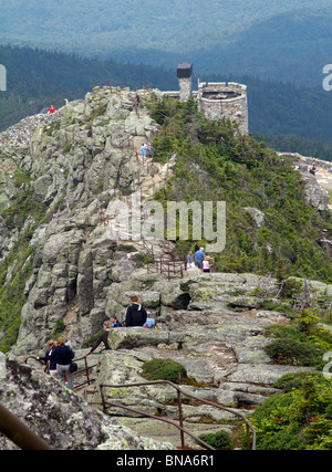 Tourists in various stages of climbing the rock stairs along the ridge line to the summit of Whiteface Mountain in New York. Stock Photo