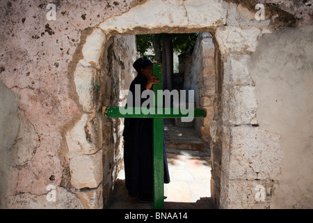 Wooden cross doorway to the residential quarters of Ethiopian orthodox monks on top of The Holy Sepulchre East Jerusalem Israel Stock Photo