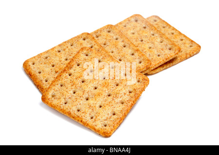 a pile of whole wheat flour crackers on a white background Stock Photo