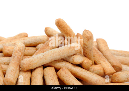 a pile of whole wheat flour breadsticks on a white background Stock Photo