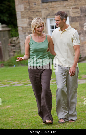 Couple in conversation, walking Stock Photo