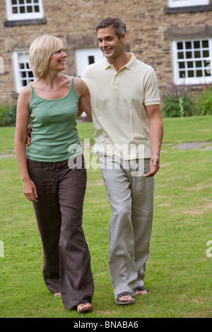 Couple in conversation, walking Stock Photo