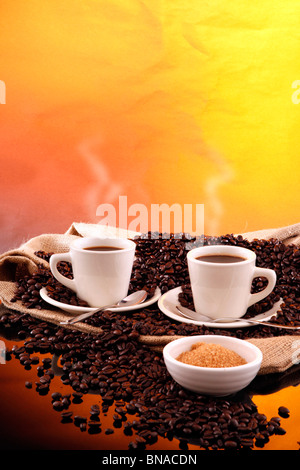 Hot cups on a sisal sack and fresh roasted beans Stock Photo