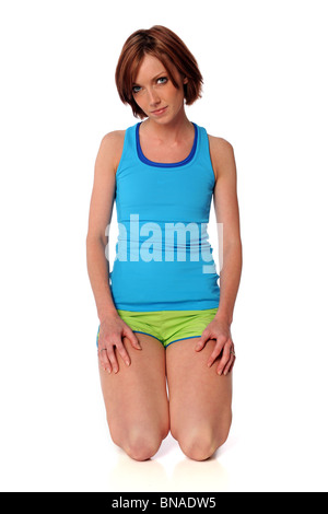 Young woman in fitness clothes isolated over white background Stock Photo