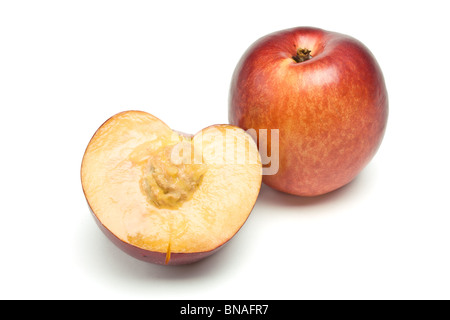 fresh vibrant Nectarine and slice with stone from low perspective isolated against white background. Stock Photo