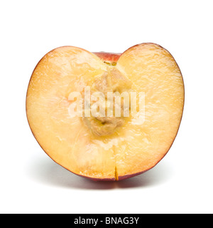 fresh vibrant Nectarine half with stone from low perspective isolated against white background. Stock Photo