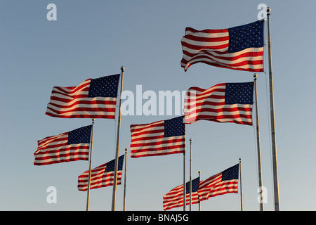 American flags flapping in the wind against a clear blue sky Stock Photo