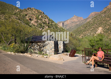 Hiker waits at Shuttle Bus stop #1, Sabino Canyon Recreation Area, Tucson, Arizona. (model released) Stock Photo