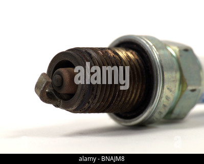 An old, battered spark plug isolated on a white background. Stock Photo