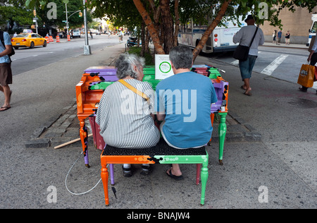 A mature couple playing Heart and Soul on a street piano in Astor Place, part of Play Me I'm Yours Sing For Hope ©Stacy Walsh Rosenstock/Alamy Stock Photo