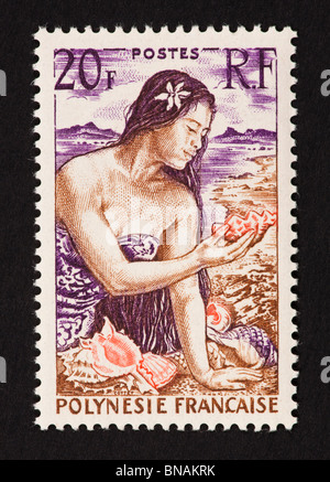 Postage stamp from French Polynesia depicting a woman with seashells. Stock Photo