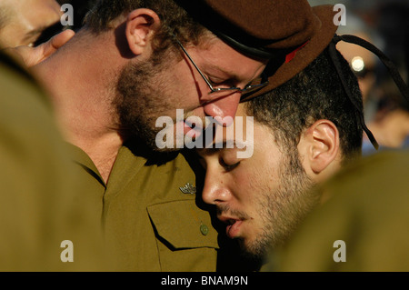 Israeli soldiers from the Golani brigade cling to each other during military funeral of a fallen soldier during the war with Hezbollah in Lebanon. Galilee Israel Stock Photo