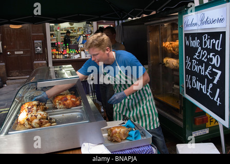 Young Farmer from Fosse Meadows free range chicken farm selling fresh chickens and rotisserie chicken at the Rupert Street Soho farmers street market. UK. 2010s 2010 HOMER SYKES Stock Photo