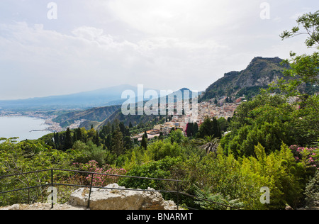 View over Taormina from the Greek Theatre (Teatro Greco) with Mount Etna in the distance, Taormina, Sicily, Italy Stock Photo