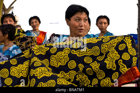Attractive Kuna Indian woman showing their painstakingly hand crafted molas to tourists, hoping for a sale. Stock Photo