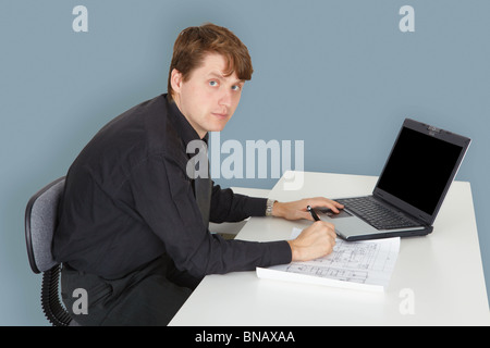 The young specialist working on a project in the office Stock Photo