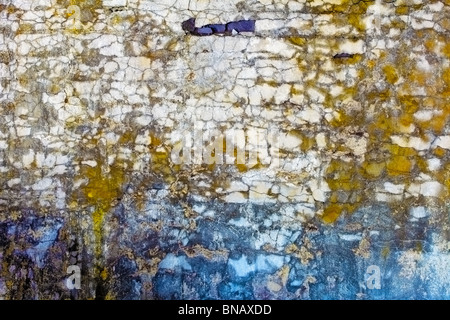 The old concrete wall with colored spots and cracks Stock Photo