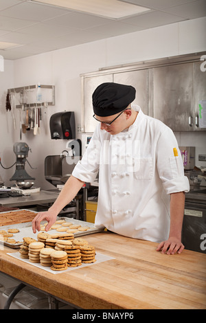 Male chef baking cookies in commercial kitchen Stock Photo