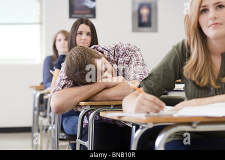 Male high school student asleep in class Stock Photo