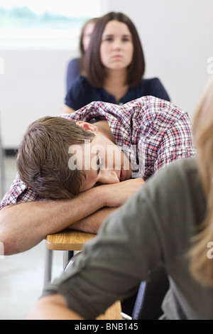 Male high school student asleep in class Stock Photo