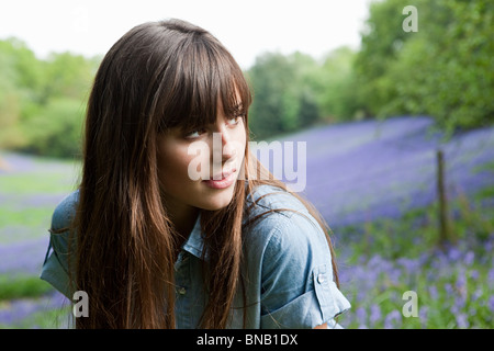 Young woman in field of bluebells Stock Photo