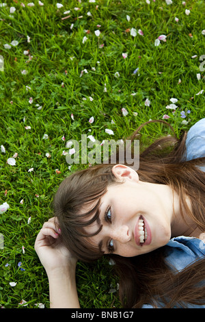 Young woman lying on grass Stock Photo