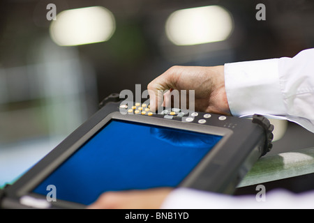Engineer using handheld computer Stock Photo