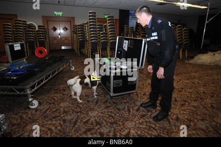 Sussex  Police officer and explosive search dog check items inside the Metropole Hotel before the Conservative spring conference Stock Photo