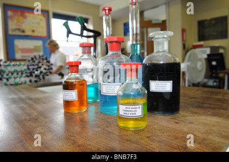 School science laboratory with bottles of chemicals ready for an experiment, a bottle of potassium chromate solution in front. Stock Photo