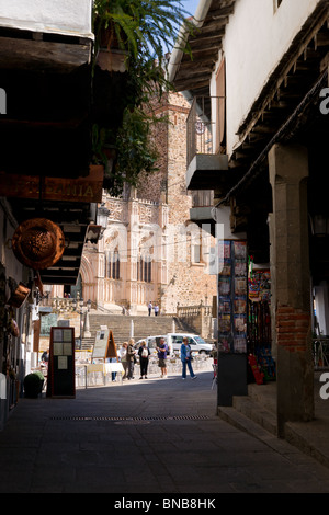 View of Royal Monastery of Santa Maria de Guadalupe from a narrow street. Stock Photo