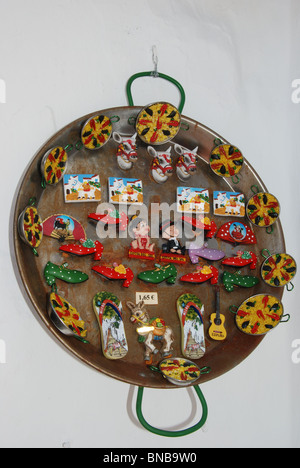 Fridge magnets displayed in a Paella Pan, Mijas, Costa del Sol, Malaga Province, Andalucia, Spain, Western Europe. Stock Photo