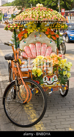 kitsch and typically decorated Rickshaw in the historical city of Melaka (Malacca) Stock Photo