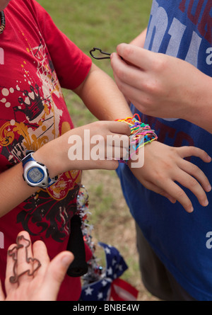 Austin, Texas USA, July 2010: Pre-teen boys trade Silly Bandz at park. ©Bob Daemmrich Stock Photo