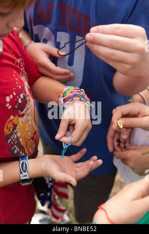 Austin, Texas USA, July 2010: Pre-teen boys trade Silly Bandz at park. ©Bob Daemmrich Stock Photo