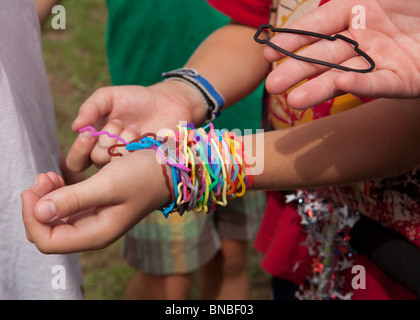 Austin, Texas USA, July 2010: Pre-teen boys trade Silly Bandz at park. ©Bob Daemmrich Stock Photo