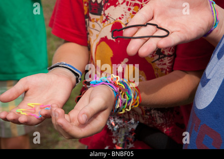 Austin, Texas USA, July 2010: Pre-teen boys trade Silly Bandz at park. ©Bob Daemmrich Stock Photo