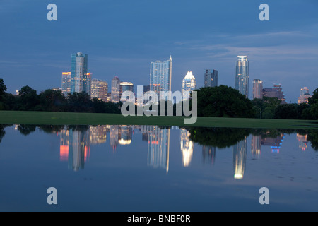 The Austin, Texas, skyline is reflected in a large pool of rainwater standing in downtown's ZIlker Park Stock Photo