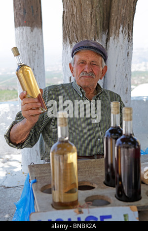 an old man selling home made wine in the mountain village of Pyrgos, Santorini Island, Cyclades, Aegean Islands, Greece Stock Photo