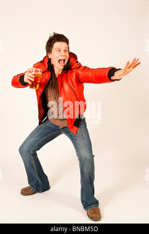 Happy young man drinking a pint of beer lager Stock Photo