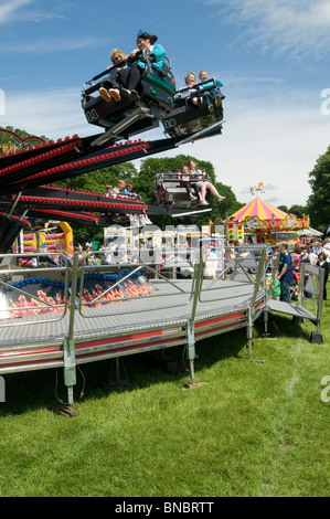 Spinning rides, waltzer at funfair in summer at night Stock Photo - Alamy
