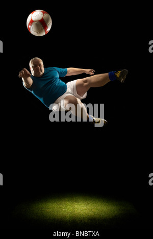 Large man doing flying volley Stock Photo