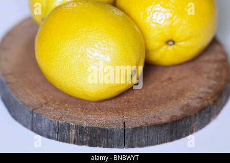 Fresh lemons on cedar wood plank. Stock Photo